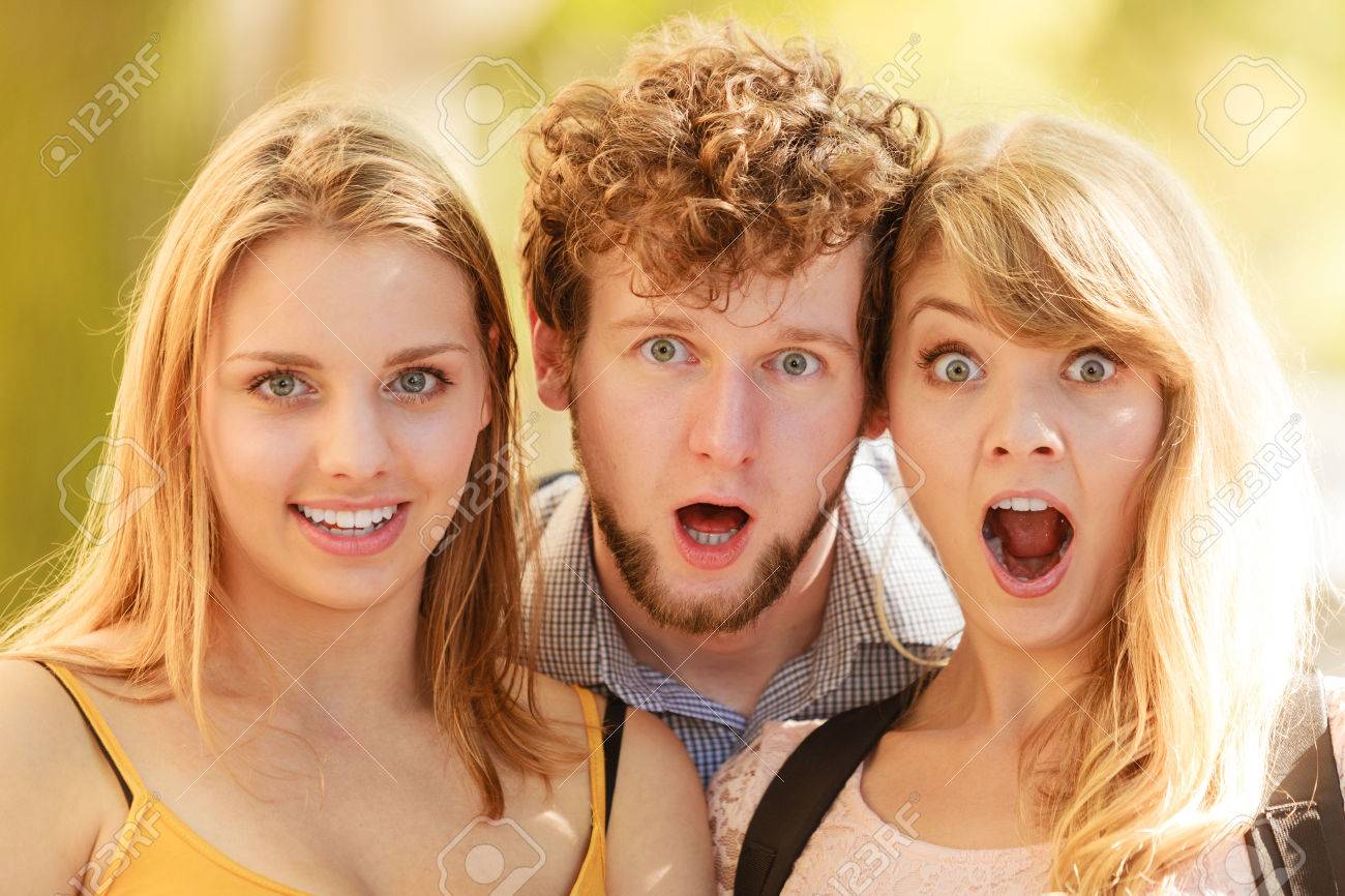 58214602-three-surprised-astonished-young-people-friends-outdoor-attractive-women-and-handsome-man-portrait-s-Stock-Photo.jpg